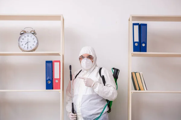 Old male contractor in office disinfection concept — Stock Photo, Image