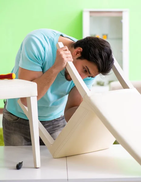 Man repairing furniture at home