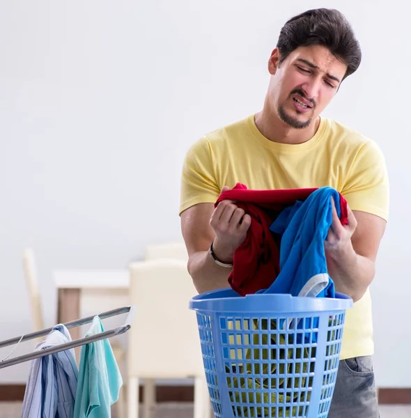 Handsome man husband doing laundering at home — Stock Photo, Image