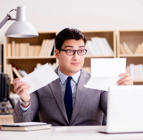 İşadamı mektup zarfını ofisinde alıyor.