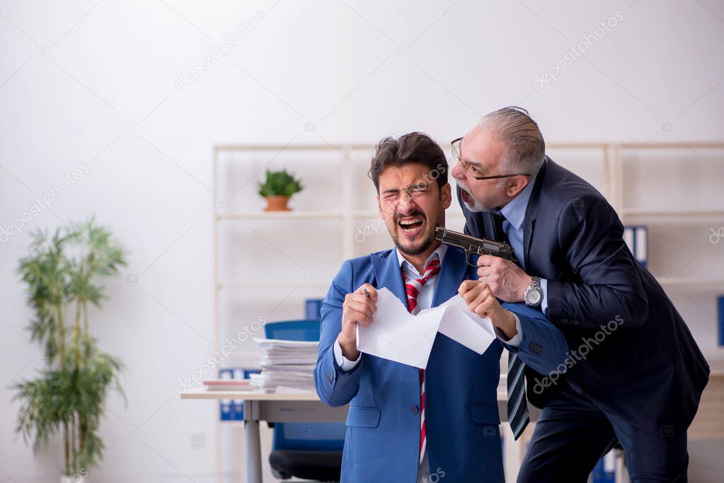 Old boss and young male employee in bullying concept