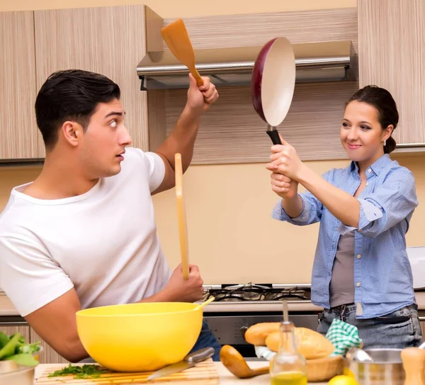 Ung familj gör roliga slagsmål i köket — Stockfoto