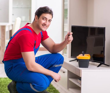 Profesyonel tamir mühendisi bozuk televizyonu tamir ediyor.