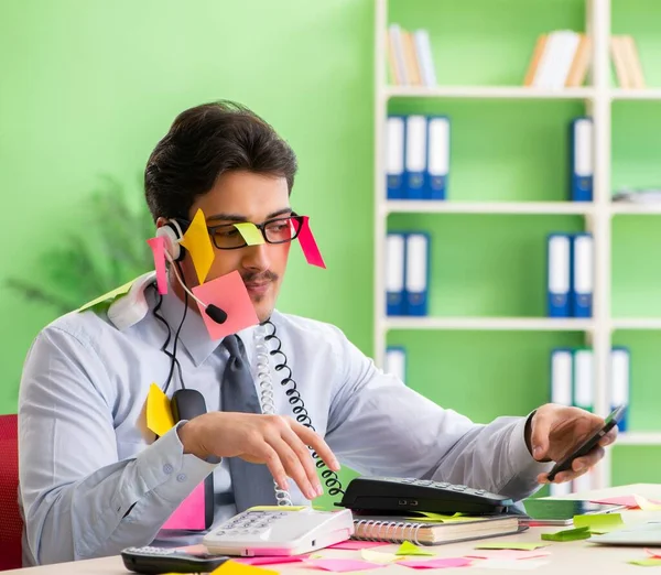 Young help desk operator working in office with many conflicting — Stock Photo, Image