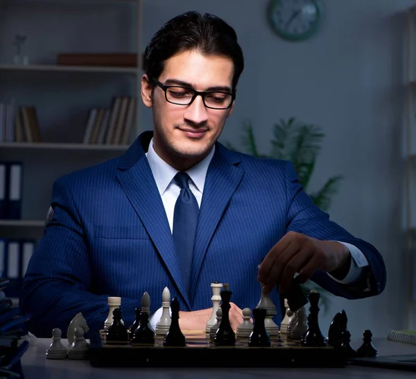 Businessman playing chess in strategy concept — Stock Photo, Image