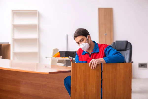 세계적 인 유행병이 일어나는 동안 사무실에서 일하는 젊은 남자 목수 — 스톡 사진