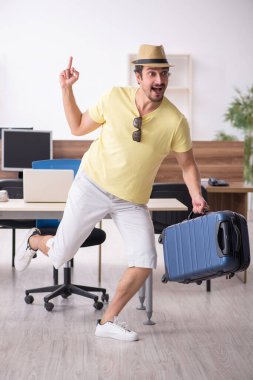 Genç bir erkek işçi iş yerinde geziye hazırlanıyor.