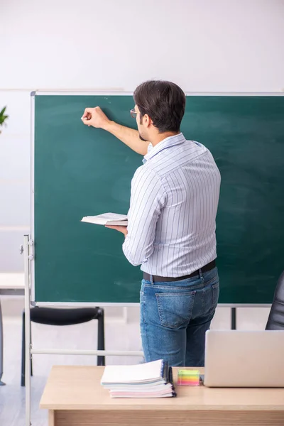 Junger männlicher Lehrer vor der Tafel — Stockfoto