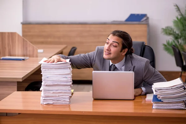 Junge männliche Mitarbeiter und zu viel Arbeit im Büro — Stockfoto