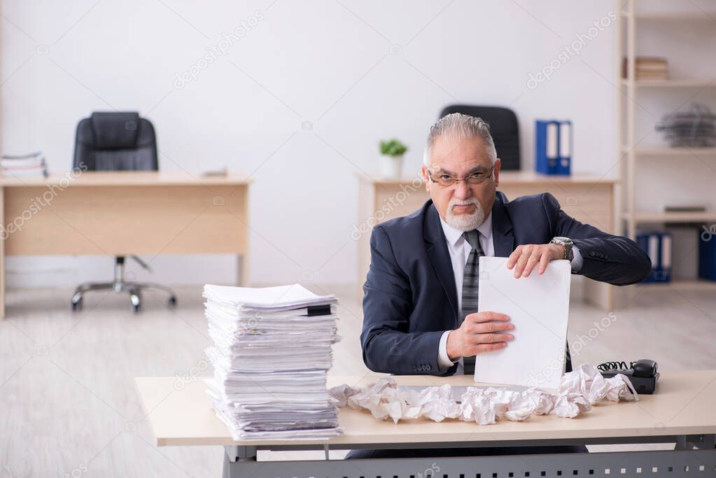 Old male employee in brainstorming concept