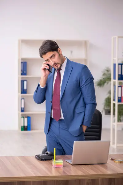 Young male employee sitting at workplace — Stock Photo, Image