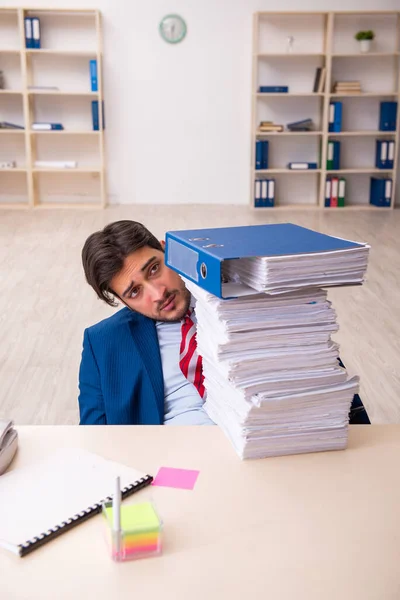 Young businessman employee unhappy with excessive work in the office — Stock Photo, Image