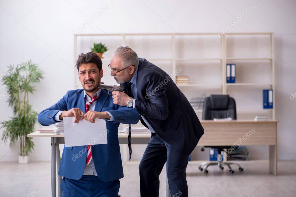 Old boss and young male employee in bullying concept
