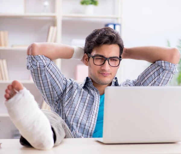 Freelancer com lesão no pé trabalhando em casa — Fotografia de Stock