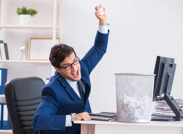 Junger gutaussehender Geschäftsmann arbeitet im Büro in Paperwo — Stockfoto