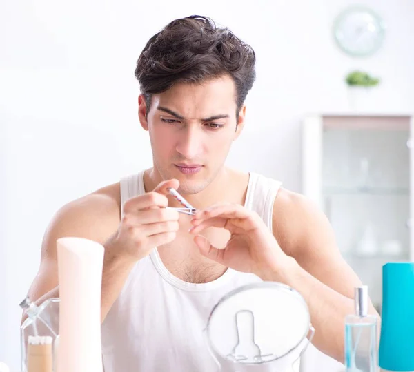 Jovem homem bonito olhando no espelho — Fotografia de Stock