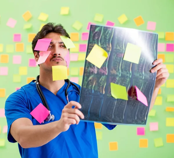 Young doctor with many reminders and urgent work — Stock Photo, Image