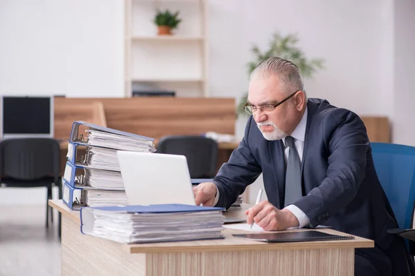 A munkahelyen ülő idősebb férfi alkalmazott — Stock Fotó