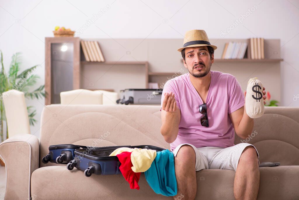 Young man preparing for trip at home