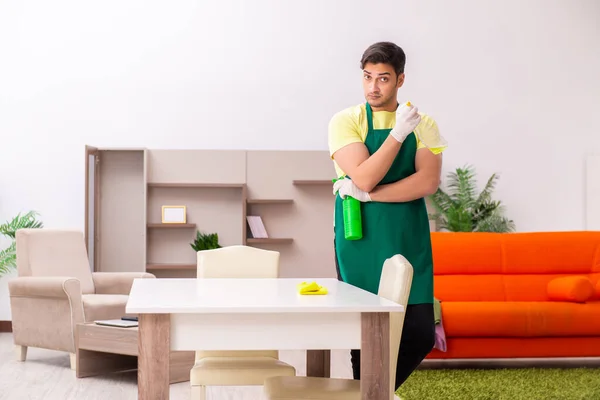 Young male contractor cleaning the house indoors — Stock Photo, Image