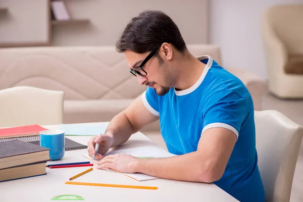 Young male student studying at home — Stock Photo, Image