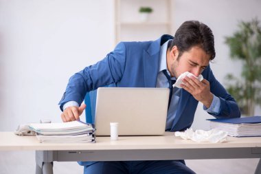 İş yerinde acı çeken genç bir erkek işçi.