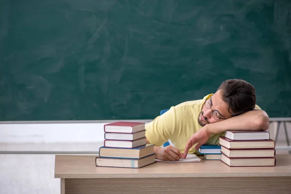 Joven estudiante masculino preparándose para los exámenes en el aula —  Fotos de Stock