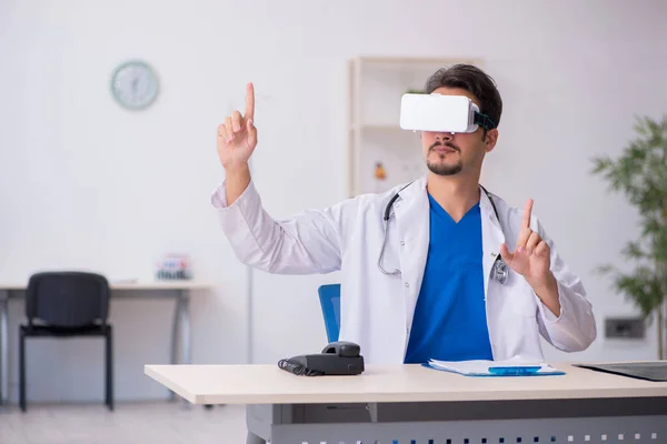 Young male doctor wearing virtual glasses in the clinic — Stock Photo, Image