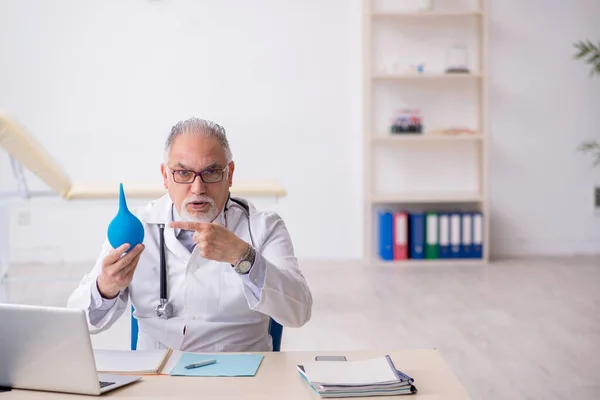 Old male doctor gastroenterologist working in the clinic — Stock Fotó