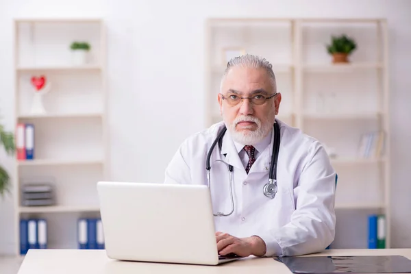 Viejo médico que trabaja en la clínica —  Fotos de Stock