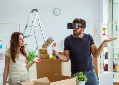 Sanal gözlüklü genç bir aile, Bo ile birlikte yeni evde bavullarını boşaltıyorlar.