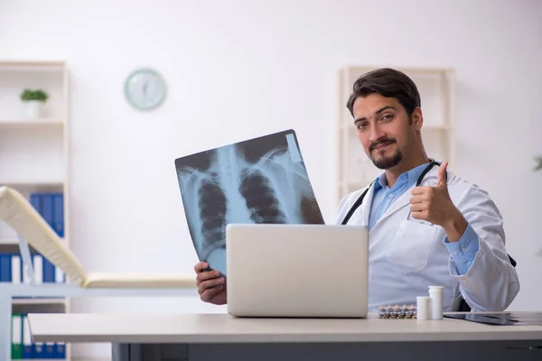 Young male doctor in wheel-chair working in the clinic — Stock Photo, Image