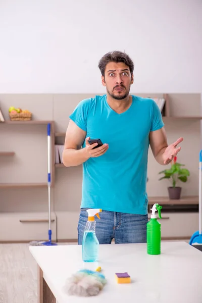 Young male contractor cleaning the house — Stock Photo, Image