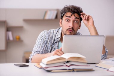 Evde sınava hazırlanan genç bir erkek öğrenci.