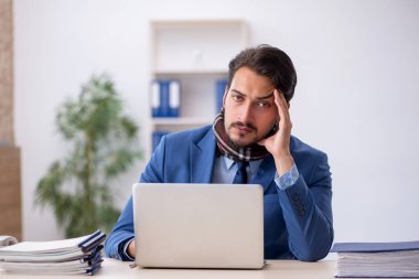 İş yerinde acı çeken genç bir erkek işçi.