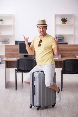 Genç bir erkek işçi iş yerinde geziye hazırlanıyor.