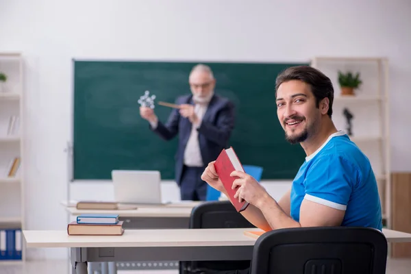 Viejo profesor de física masculino y joven estudiante masculino delante de Blac —  Fotos de Stock