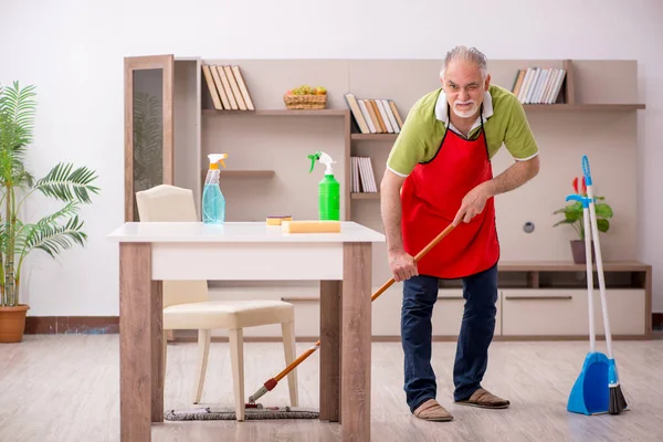 Alter Mann putzt das Haus — Stockfoto