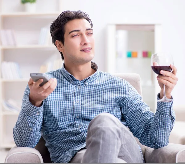 Young man drinking wine at home — Stock Photo, Image
