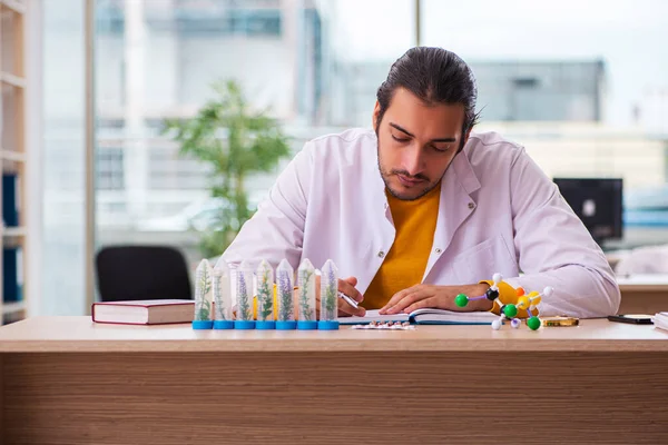 Young male chemist in drug synthesis concept — Stock Photo, Image