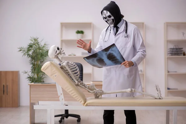 Djävulsk läkare radiolog undersöker skelett patient — Stockfoto