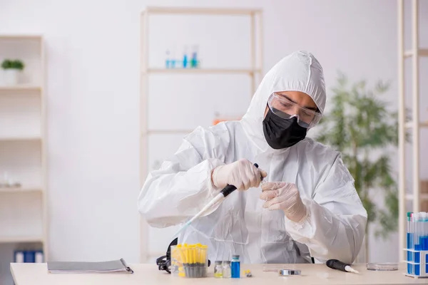 Ahli kimia laki-laki muda bekerja di laboratorium selama pandemi — Stok Foto