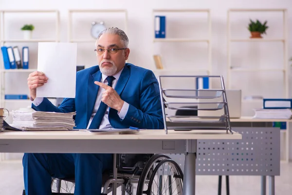 Ancien employé masculin en fauteuil roulant assis dans le bureau — Photo