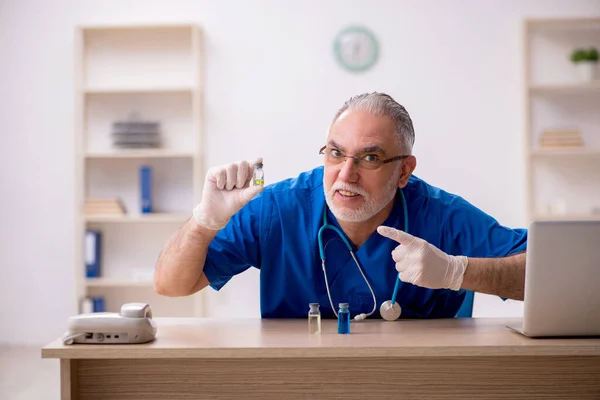 Velho médico do sexo masculino no conceito de vacinação — Fotografia de Stock