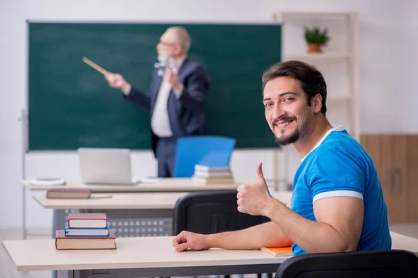 Old male physics teacher and young male student in front of blac — Stock Photo, Image