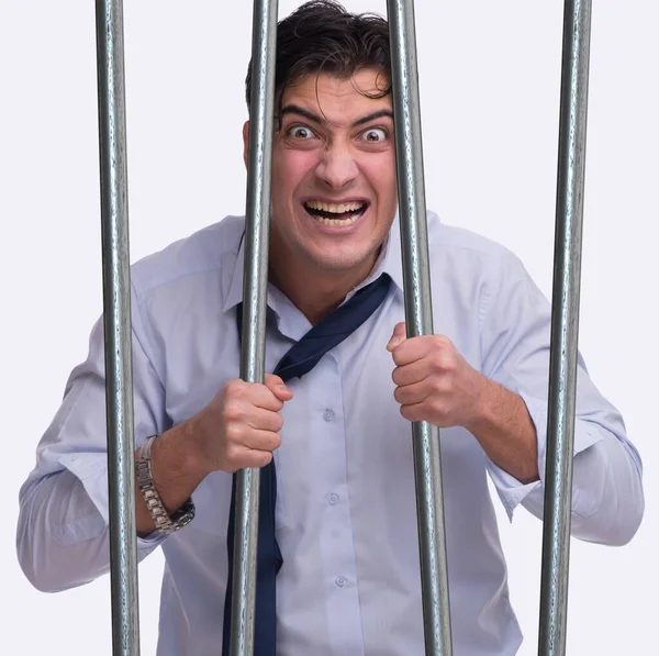 Young businessman behind the bars in prison — Stock Photo, Image