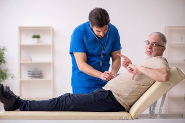 Yaşlı erkek hasta, genç doktor.