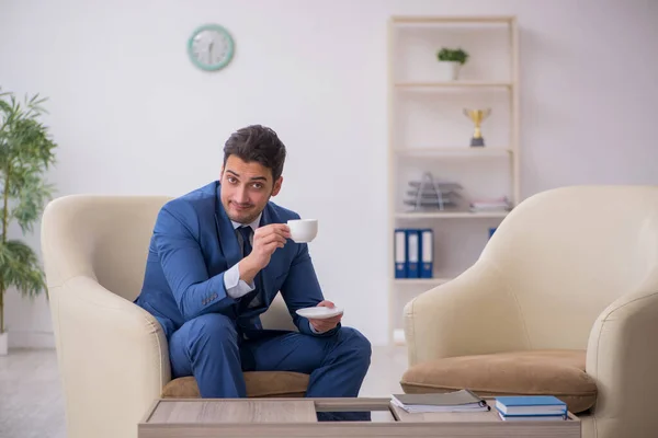 Young male employee waiting for business meeting — Stock Photo, Image