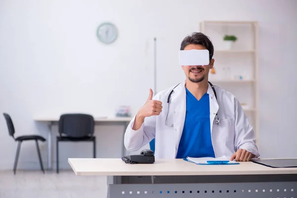 Young male doctor wearing virtual glasses in the clinic — Stock Fotó