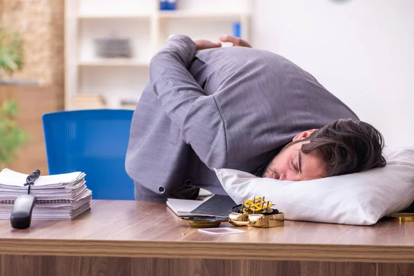 Young male employee in oversleeping concept — Stock Photo, Image